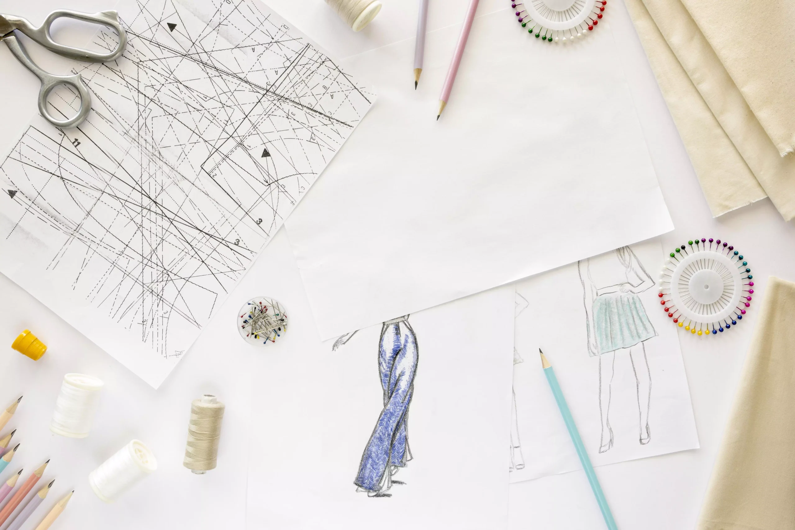 top-view-sewing-essentials-with-textiles-drawing